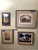 Four vintage framed silhouette artworks mounted on wall, showing variety in size and frame style.