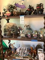 Wide shot of shelves showing assorted decorative figurines and collectibles including animals, holiday village, and miscellaneous items