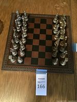 Top view showing full chess set and wooden board with carved edges arranged for play.