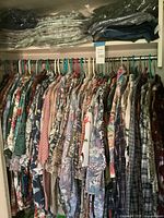 View of hanging shirts on closet rod showing various patterns and colors