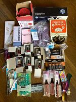 Overview of lot showing watches in boxes, various other items in background