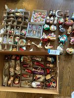 Top view of three cardboard divider boxes showing assorted ornaments in individual compartments