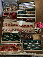Overview of various boxes and tins containing multiple glass garlands and loose ornament beads