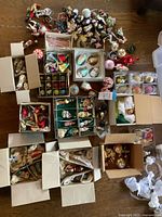 Overhead view of multiple open boxes and loose ornaments on tabletop
