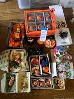 Overview of full assortment of approximately 20 ornaments arranged on tabletop