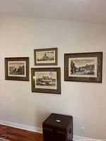 Overview of four framed engravings mounted on wall