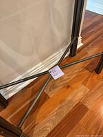 Close-up photo of metal cross brace detail on the legs with a 22-inch note for reference.