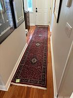 Full-length view of runner rug in hallway showing overall design and condition