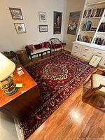 Full room view showing the rug beneath furniture on hardwood floor.