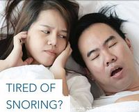 Photo showing a woman covering her ears looking displeased while a man next to her is snoring with mouth open, illustrating the problem of snoring.