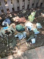 group of nine animal statues on garden soil