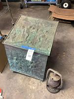 Patinated embossed metal chest and lantern side view