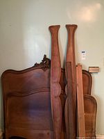 Headboard, footboard and side rails leaning against wall