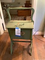 Full view of green wooden sewing box with handle and floral paint