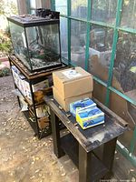 Aquarium on stand with side table and boxed accessories