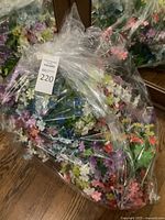 Bag filled with assorted artificial flower bunches