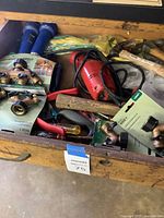 Drawer view showing packaged Orbit manifolds, blue hoses, red drill, hand tools