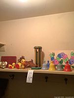 shelf with pull toys, bell set, puzzle, stacking tower, book, cutout