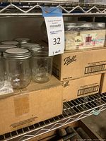 Closed Ball cases and loose jars with metal lids on wire shelf
