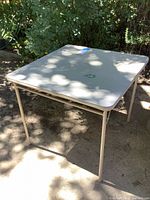 Full view of beige folding table outdoors