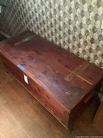 Angled top and side view of closed cedar chest
