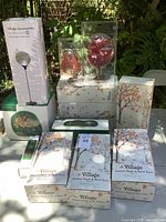 Group view of all boxed and packaged Department 56 accessories on table