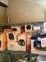 Shelf with multiple Department 56 Halloween boxes