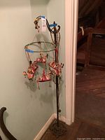 Full view of mobile hanging from floor lamp stand