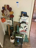 Group view: turkey sign, snowman plaque, ceramic planter, tree cutouts, boxed solar peacock