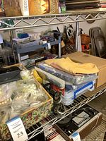 Shelf showing yellow folded T-shirt, boxed beads and accessories