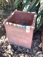 Front view of square terracotta planter outdoors