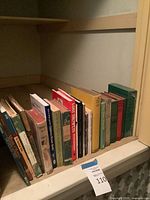 Shelf showing all 17 hardcovers standing in a row