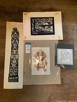All four prints laid out: totem pole, landscape, old man, small blue figure