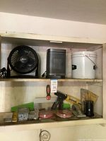 Shelf with fan, heater, bucket and assorted tools