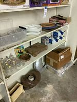 Shelving with majority of assorted items including Magnavox box, glassware, ceramics, weights, art and misc pieces