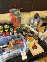 Overall view of assorted sprays, tools, organizer and horn kit on table