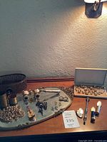 Overview of lot on dresser showing opera glasses, lipstick cases, jewellery, brass items and vanity tray