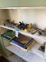 Full shelf view showing collectibles, tools and books