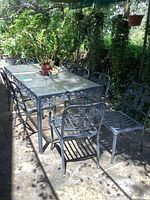 Full view of dining table and eight chairs in outdoor setting