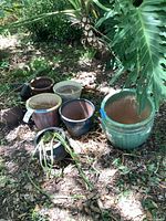 Group of eight assorted planters on ground