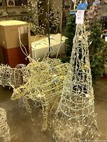 Overall view of reindeer and cone tree figures with lights