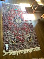 Full view of Persian area rug on hardwood floor