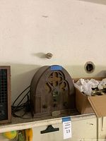 Cathedral radio beside wood-grain air purifier on shelf