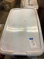 Closed plastic tote containing the lot