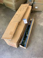 Closed and open shipping boxes with tree sections visible