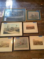All seven framed prints laid out on floor