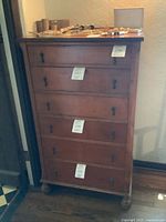 Front view of tall 5-drawer wooden chest