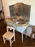 Front view of vanity with tri-fold mirror and matching chair