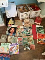 Overall lot with boxes and spread of books and magazines visible