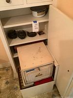 Shelf with metal box, books, ceramic cat heads and enamel pot